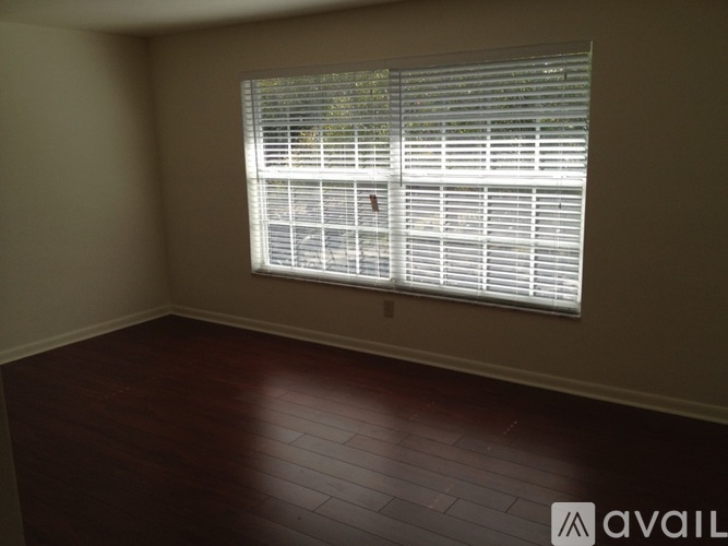 A room with a window covered in blinds.