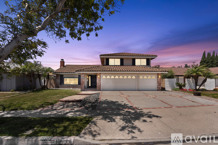 A house with a driveway and garage is available for sale.