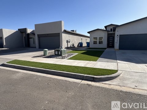 A house with a garage and a driveway in front.