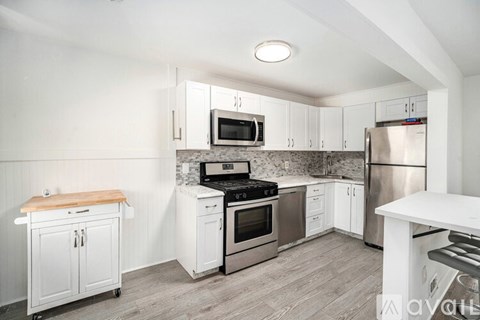 A kitchen with white cabinets and stainless steel appliances.