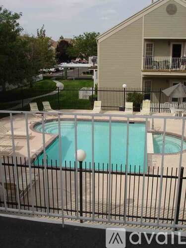 A pool surrounded by a black fence with the logo Avail on it.