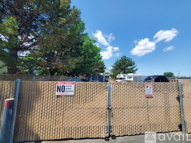 A fence with a "NO TRESPASSING" sign attached to it.