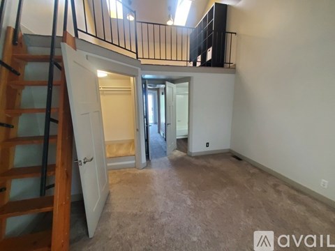 A hallway with a patterned carpet leads to a bedroom.