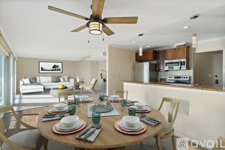A dining room with a table set for a meal.