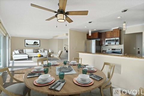 A dining room with a table set for a meal.