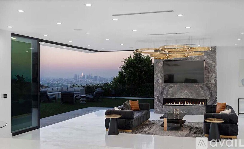 A modern living room with a view of the city skyline.