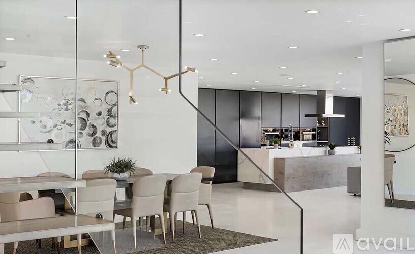 A modern dining area with a glass table and chairs.