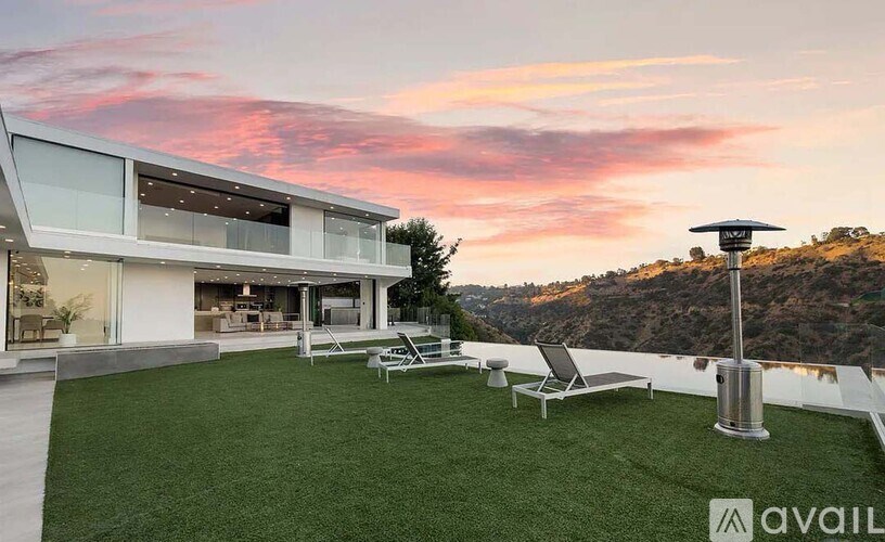 A modern house with a large outdoor seating area.