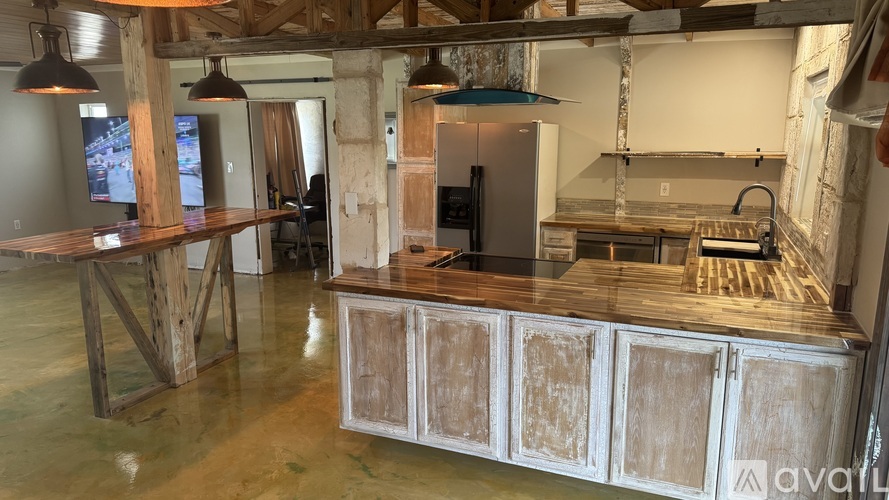 A kitchen with wooden cabinets and a large island.