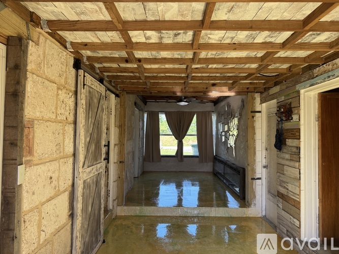 A wooden ceiling with a window in the middle.