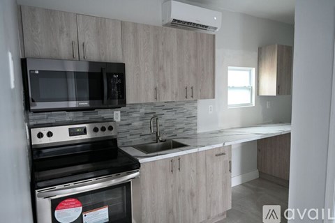 A modern kitchen with wooden cabinets and stainless steel appliances.