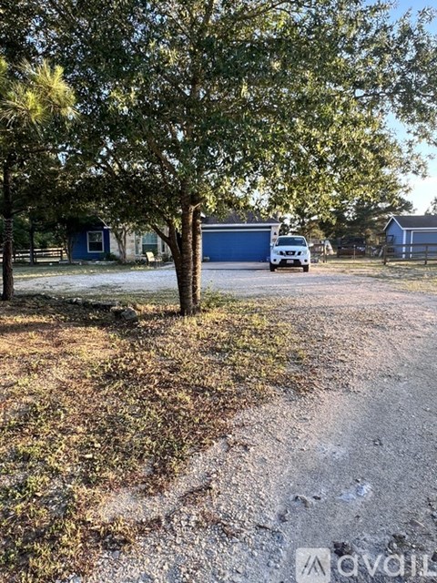 A white van is parked in a driveway with a blue garage door in the background.