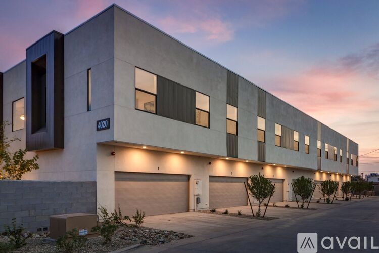 A modern building with a garage door and a sign that says "available".
