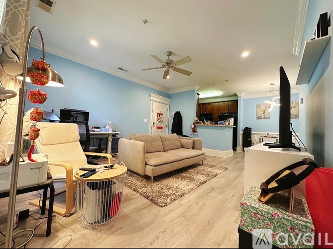 A living room with a yellow chair and a white couch.