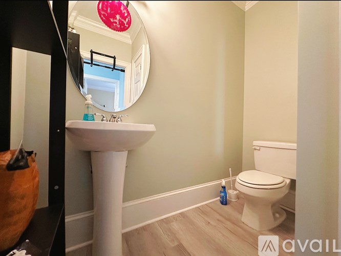A bathroom with a white sink and toilet.