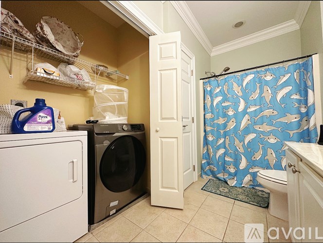 A small laundry room with a washer and dryer.