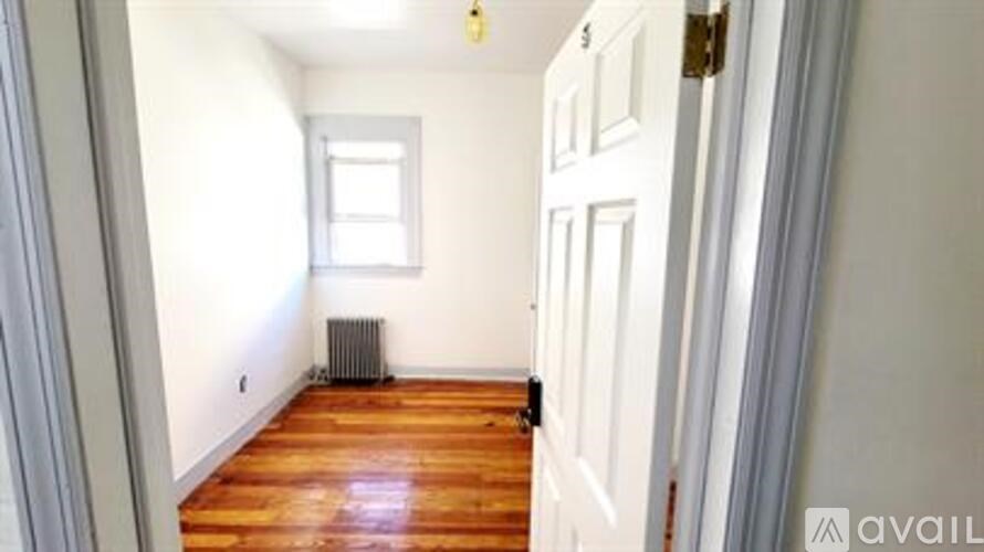 A room with wooden floors and a white door.