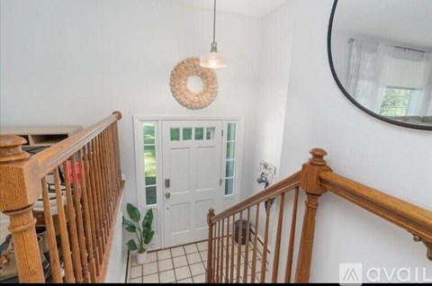 A wooden staircase with a white door at the end.