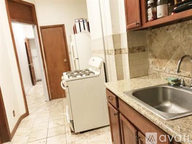 A kitchen with a white refrigerator and a white dishwasher.