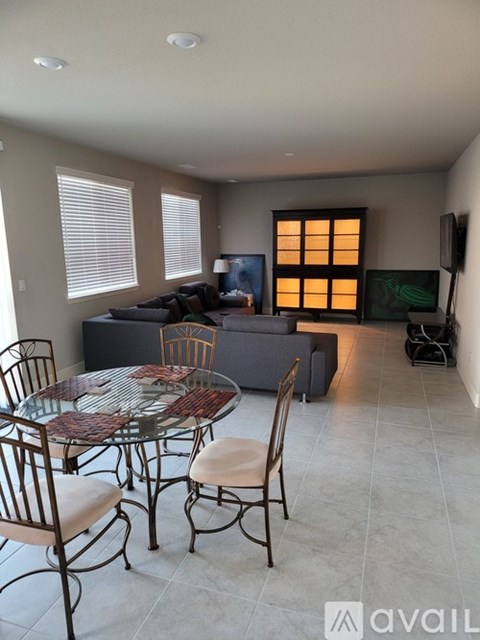 A living room with a glass table and chairs.