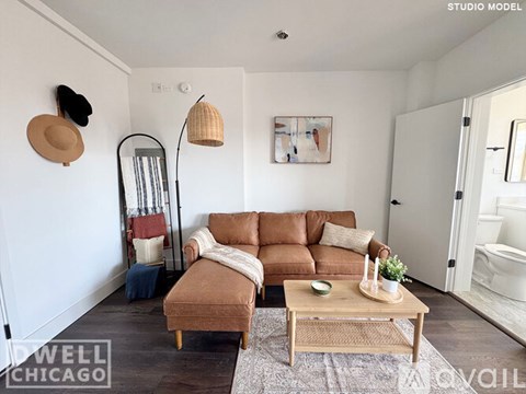A living room with a brown couch and a coffee table.