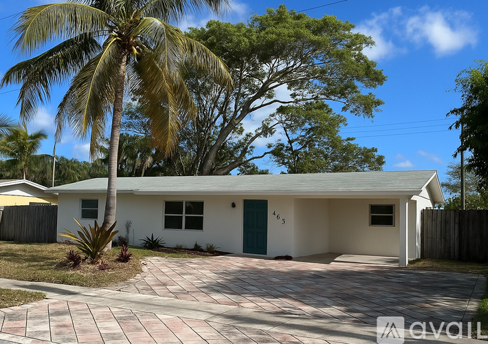 A house with a palm tree in front of it.