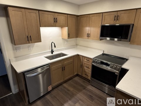A kitchen with wooden cabinets and stainless steel appliances.