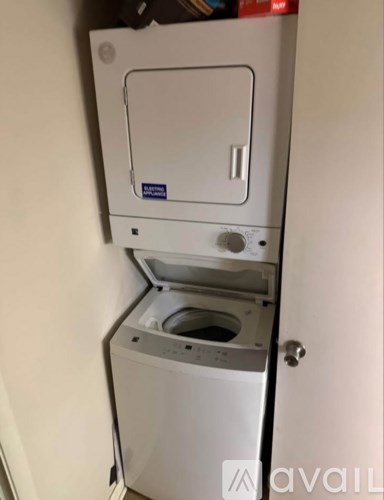 A black truck is parked in a driveway.