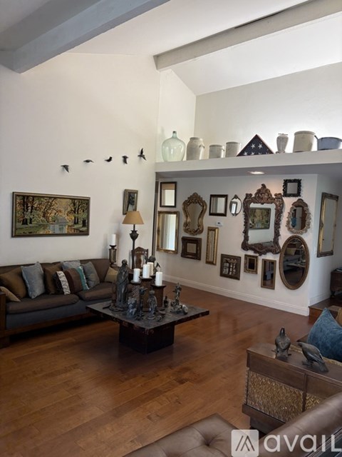 A living room with a brown couch and a coffee table.