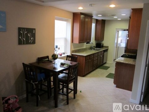 A kitchen with a table and chairs in the middle of the room.