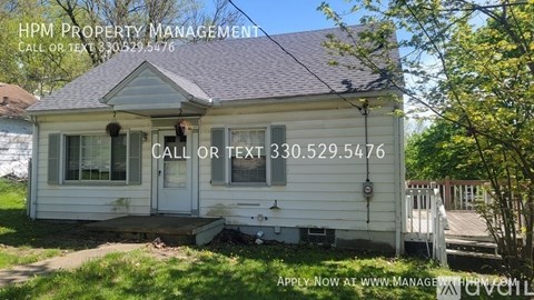 A house with a sign for HPM Property Management in front of it.