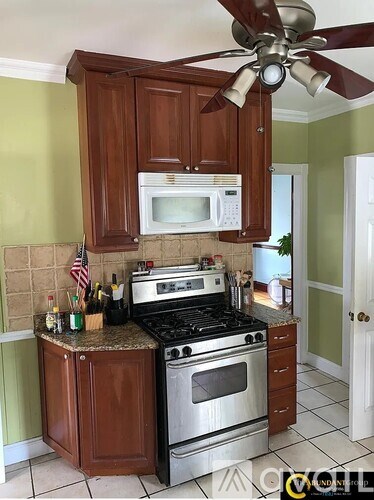A kitchen with a stove top oven and microwave above it.