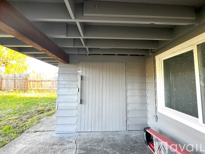 A white house with a grey roof and a white door.