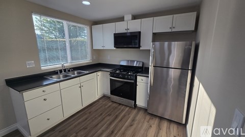 A kitchen with a stainless steel refrigerator and oven.