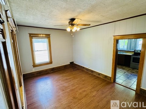 A room with wooden floors and a ceiling fan.