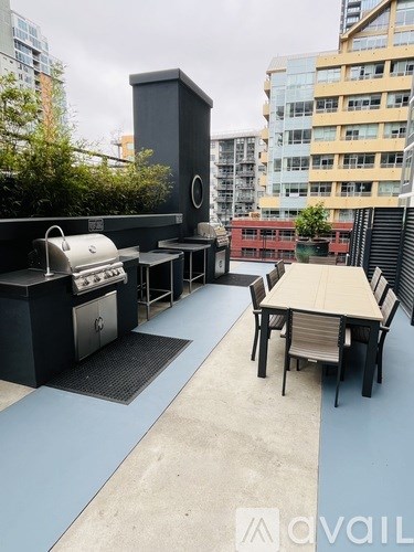 A patio with a grill and seating area.