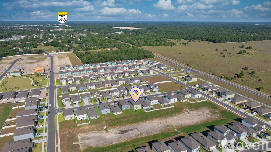 A bird's eye view of a residential area with a large open space in the center.