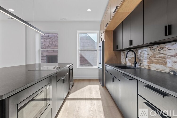 A modern kitchen with stainless steel appliances and wooden accents.