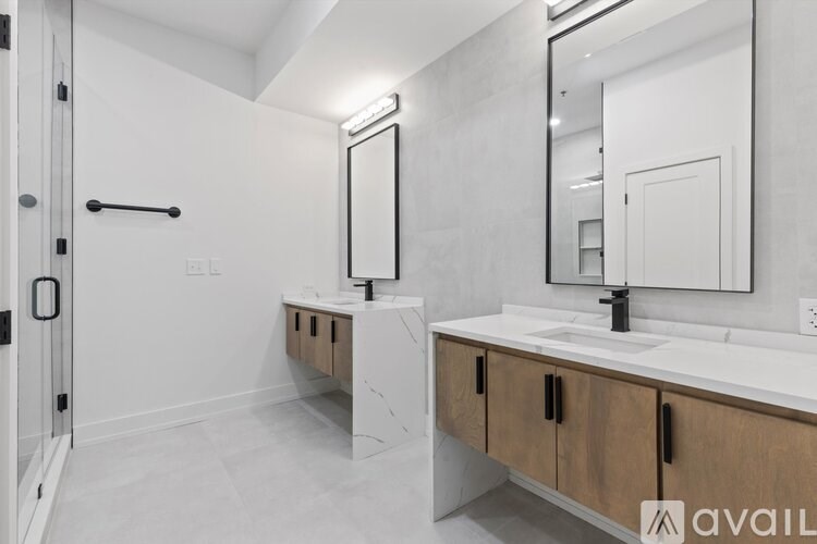 A bathroom with a sink, mirror, and a towel bar.