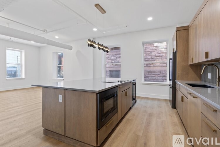 A kitchen with wooden cabinets and a black oven.