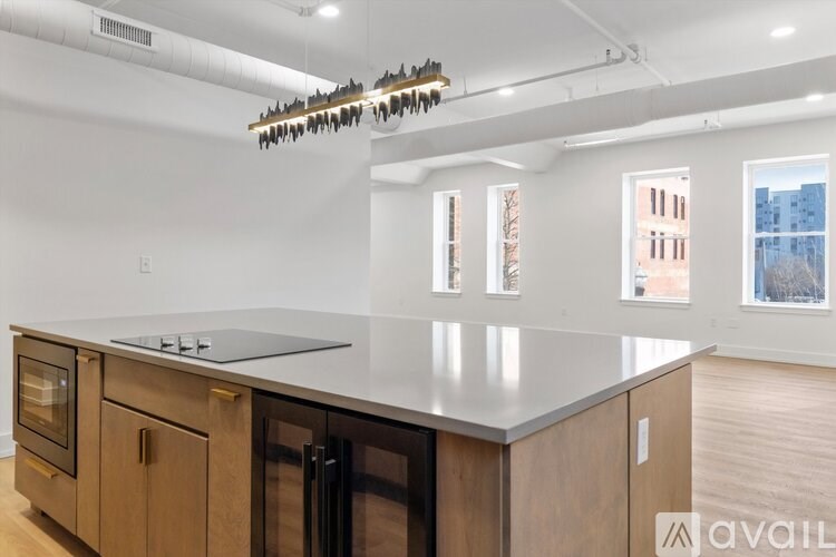 A kitchen with wooden cabinets and a black countertop.