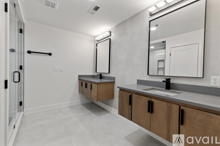 A bathroom with a sink, mirror, and wooden cabinets.