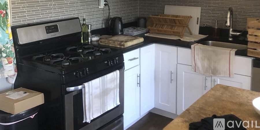 A kitchen with a white fridge and a washing machine.