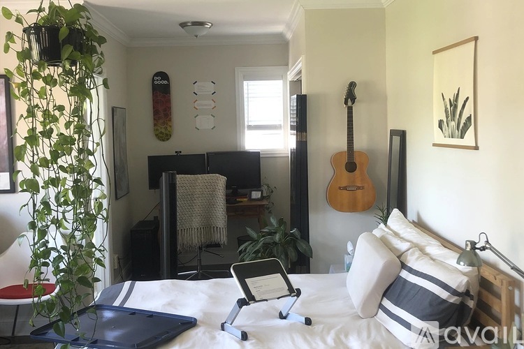 A bedroom with a bed, dresser, and mirror.