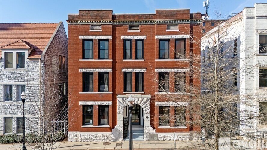 A red brick building with a black door and windows.