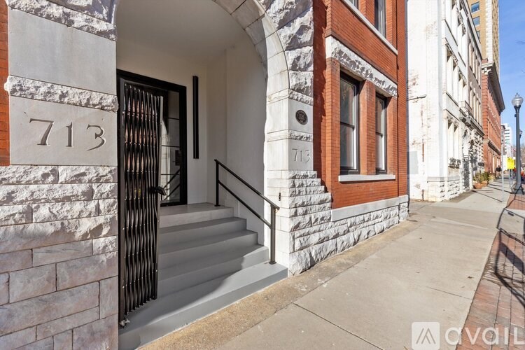 A house numbered 713 is shown with a black gate and steps leading to the entrance.