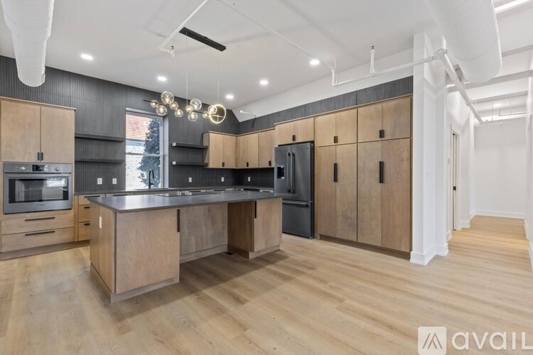 A modern kitchen with wooden cabinets and a central island.
