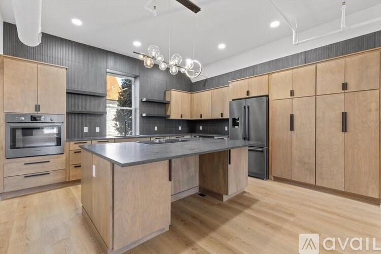 A modern kitchen with wooden cabinets and a central island.