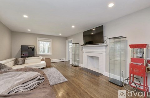 A living room with a grey sofa and a wooden floor.