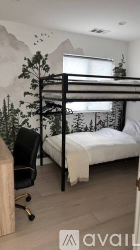 A bedroom with a bunk bed and a chair.